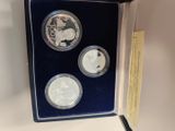 a couple of silver coins sitting in a box on a table