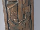 sculpture of a man holding a piece of wood in his hand