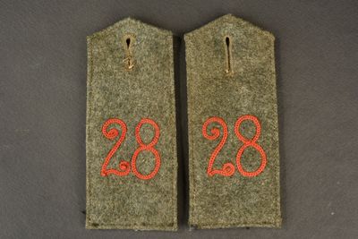 two tags with the numbers 28 and 28 on them on a table