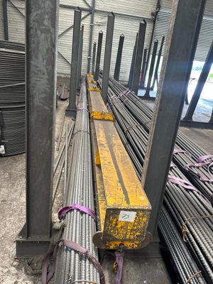 a large pile of steel pipes sitting in a warehouse