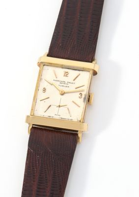 an image of a gold plated wrist watch with a brown leather strap