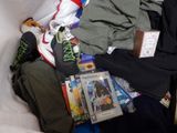 a pile of clothing and other items on a bed