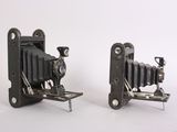 pair of antique camera on stand on white background