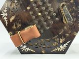 une petite horloge en bois munie d'un bracelet en cuir