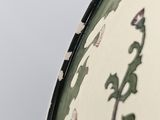 a close up of a vase with a plant on it