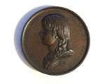 an image of a bronze coin with a woman ' s profile on it