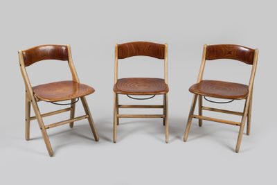 trois chaises pliantes en bois avec des assises en cuir marron sur fond gris