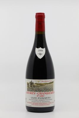 une bouteille de vin rouge posée sur une table blanche