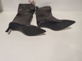 pair of black leather ankle boots on a white surface