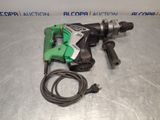 an electric drill is laying on a table next to a cord