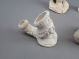 four small ceramic figurines of a woman and a man