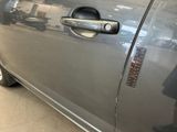 a close up of a car door handle with a sticker on it