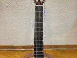 an acoustic guitar sitting on top of a wooden floor next to a wall
