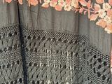 a close up of a black shawl with pink flowers on it