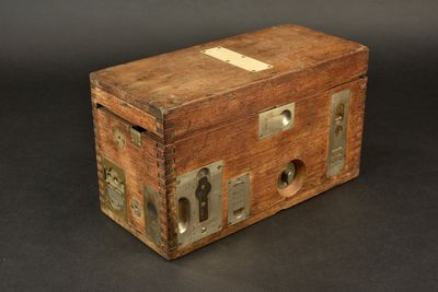an old wooden box with a lock on it