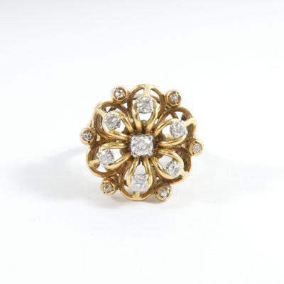 a close up of a gold ring with diamonds on a white background