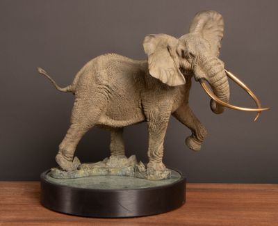 a statue of an elephant that is standing on a table