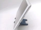 a tablet computer sitting on a stand on a white surface