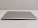 the laptop is sitting on a white surface with a white background
