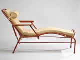 an image of a chaise lounger with a hat on top of it