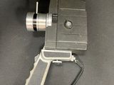 an old movie projector with a camera attached to it