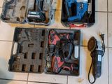 many tools that are sitting on the floor next to a person ' s feet