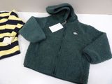 a green jacket and a yellow and black striped shirt