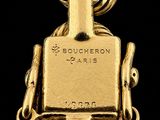 an image of a close up of a gold watch on a chain