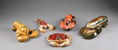 several small ceramic figurines of animals and birds on a gray surface