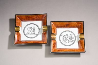 pair of small square ashtrays decorated with images of a man and a woman