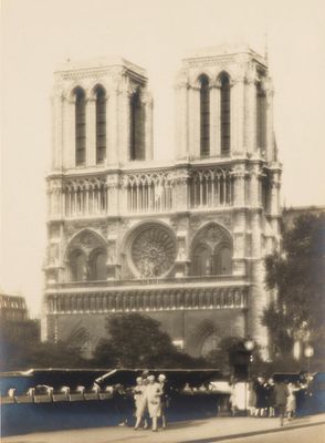 people standing in front of a large cathedral with a clock on it ' s side