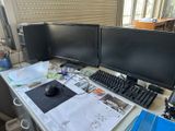 a desk with two computer monitors and a keyboard on it