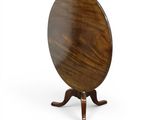 une table ronde avec un piètement et un plateau en bois