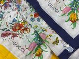 a close up of a scarf with flowers on it