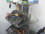 a picture of a metal shelving with many tools on top of it