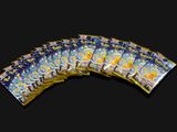 many packs of pokemon cards on a black background