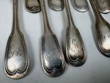 six spoons that are sitting on a table