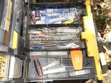 many tools in a tool box on the ground