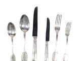 five forks, a knife, and a spoon on a white surface