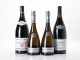 three bottles of wine are lined up on a white surface