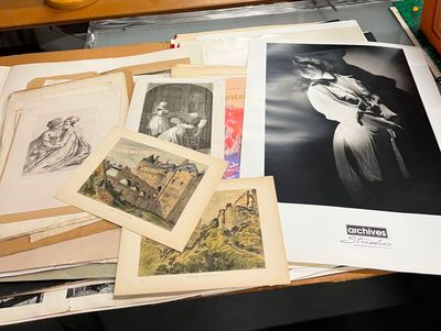 de nombreuses photos posées sur un bureau, avec une horloge en arrière-plan