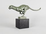 statue of a running cheetah on a marble base