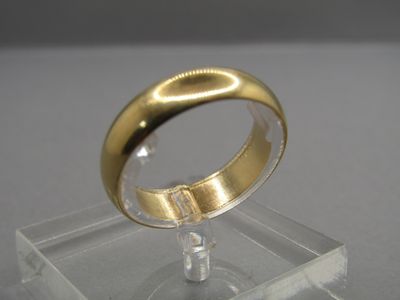 a gold ring sitting on top of a clear display case