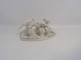 porcelain figurine of two birds sitting on top of a white plate