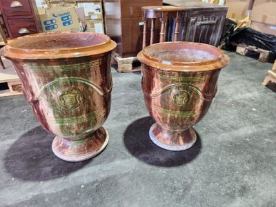 two vases that are sitting on a table