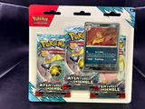 two pokemon trading cards in a package on a black surface