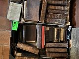 a suitcase full of old books on the floor
