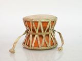a small drum that is sitting on a white surface