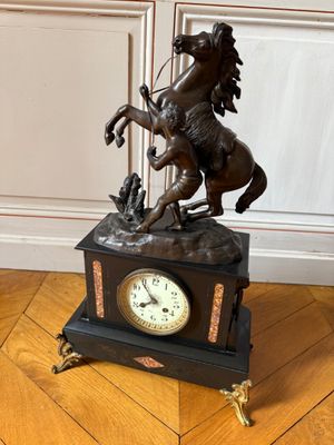 a bronze statue of a man on a horse on a clock