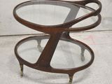a close up of a table with a glass top and metal legs
